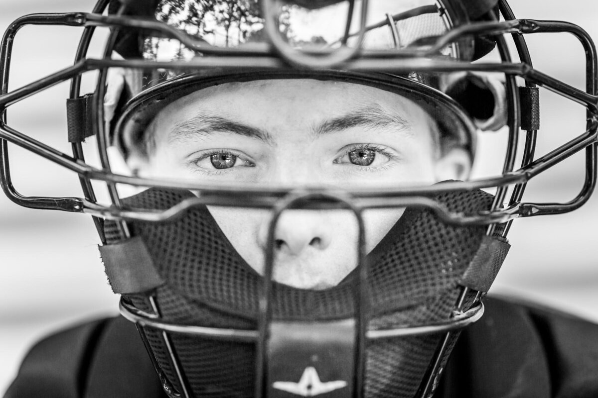 This senior wanted a portrait in his catcher gear so we got a close up shot of her face mask and his eyes.