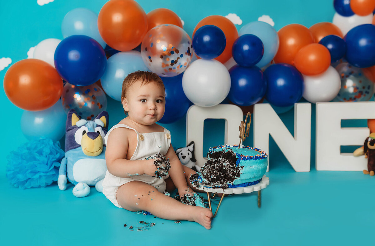 Baby enjoys cake during Cake Smash Photos in Asheville, NC..