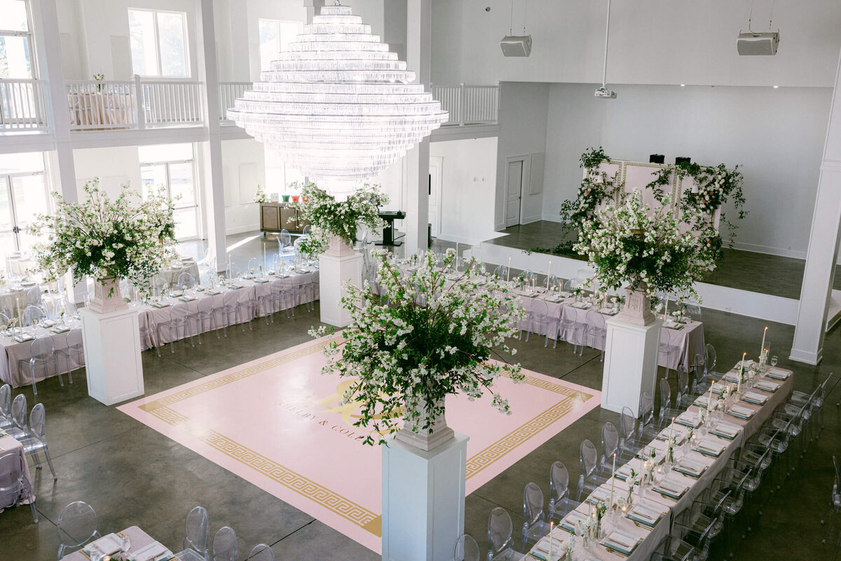 A wedding photo of the reception space showing off  florals and decorations