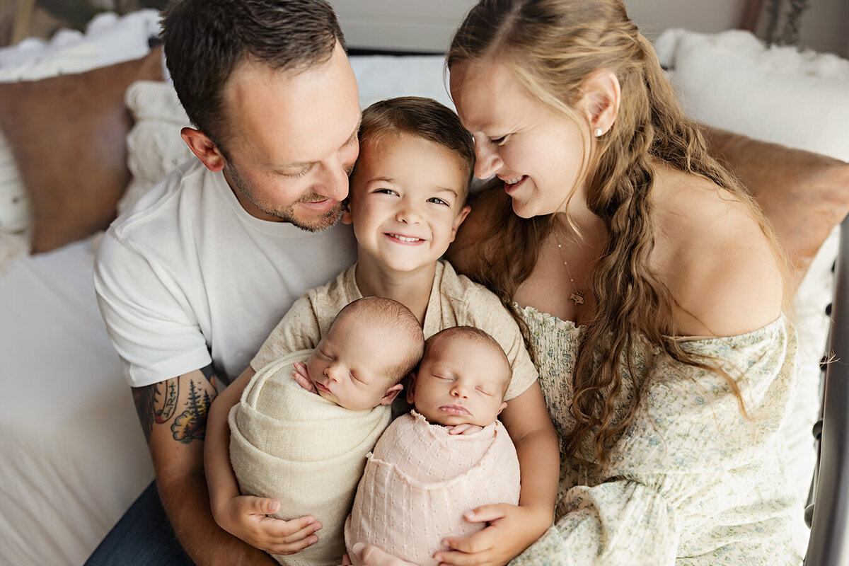 Fort Collins twin babies with family showing how excited they are to be a family