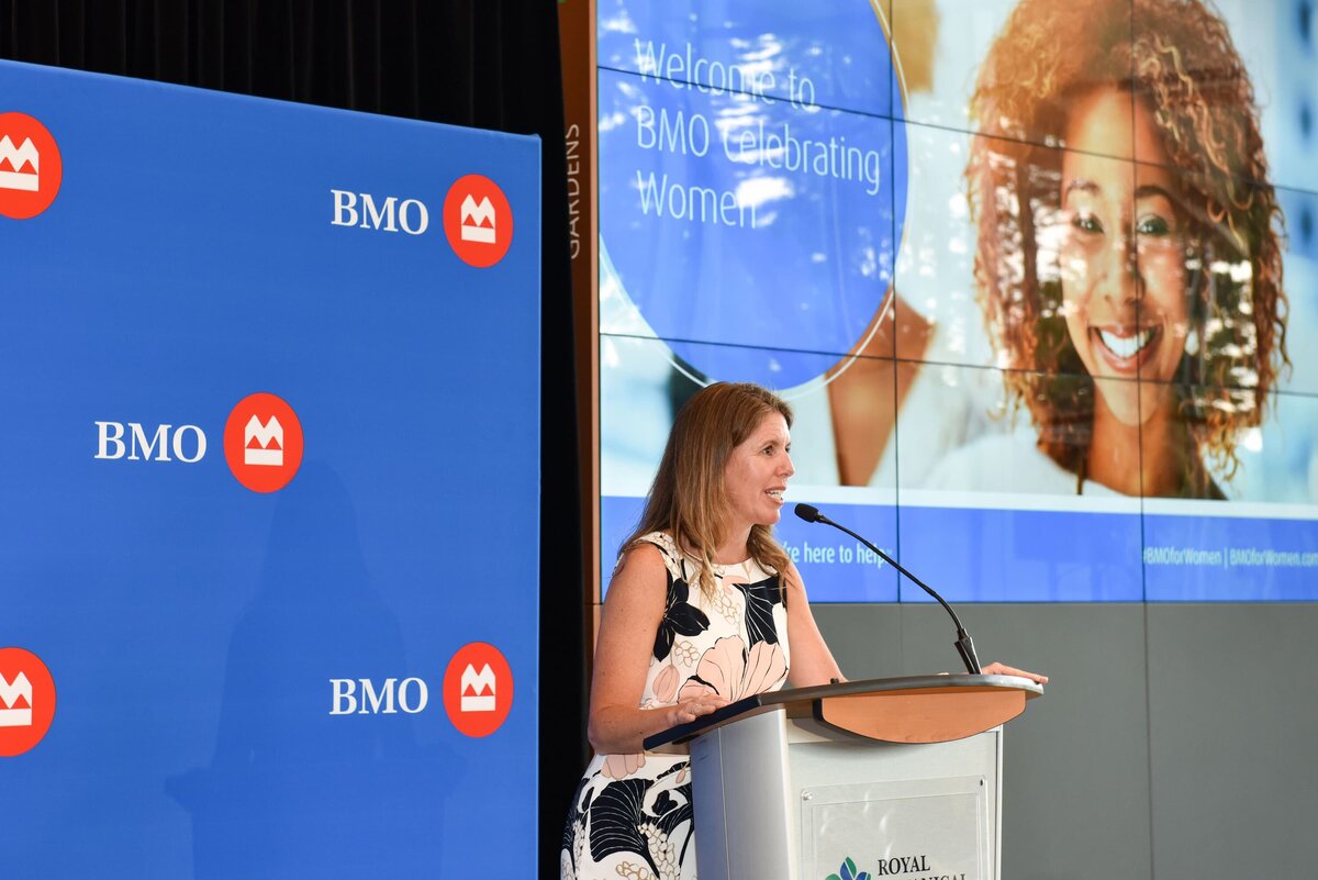 A dynamic speaker addressing an audience at a corporate event in Toronto, showcasing professional event photography services
