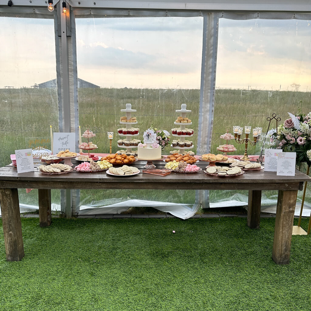 Dessert table at a rustic wedding reception, cakes and desserts created by Chartier YYC, elegant cakes & desserts in Calgary, AB, featured on the Brontë Bride Vendor Guide.