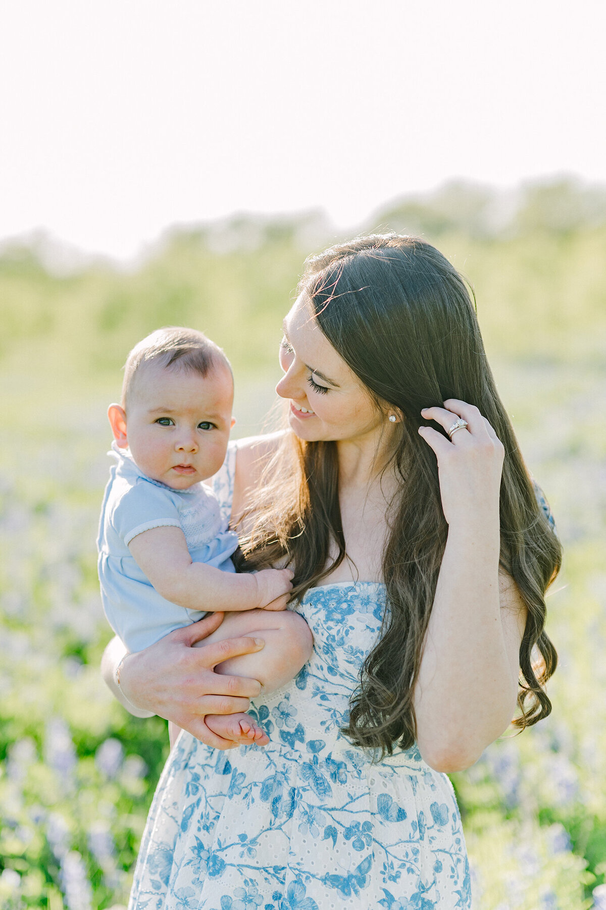 A mom adoring her baby in a field of bluebonnets in Dallas, Texas