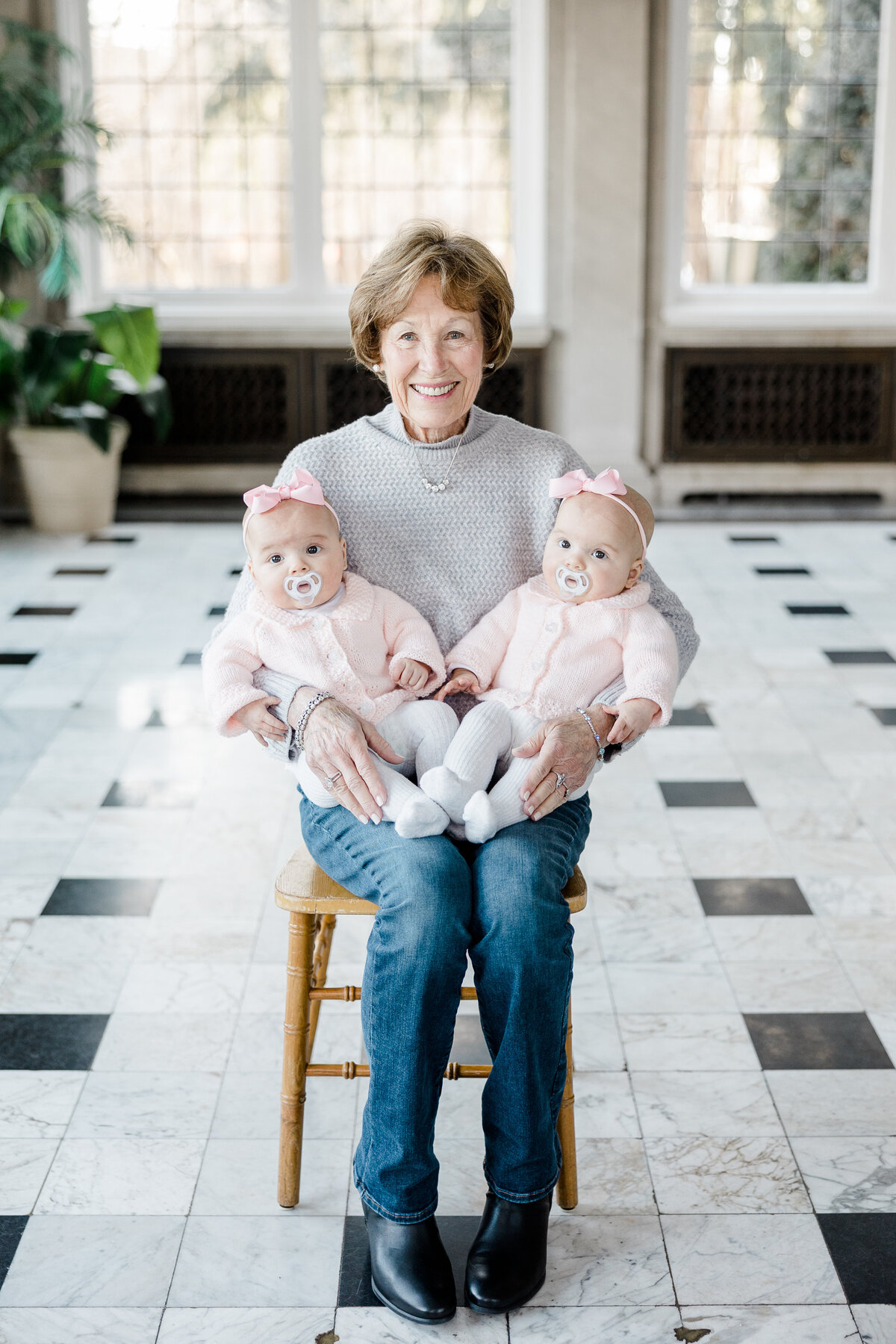 great grandmother holding her twin great grandchildren during family photos at Laurel Hall