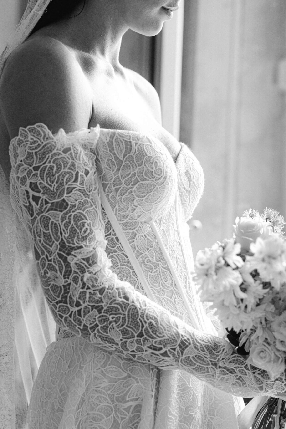 A black and white wedding photo of a bride in her white wedding dress at villa balbiano on lake como