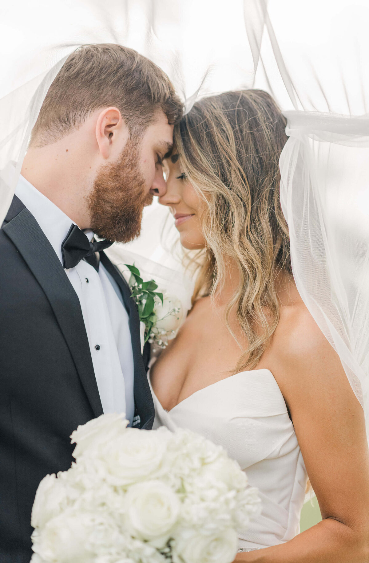 Alabama bride and groom  standing close with noses touching