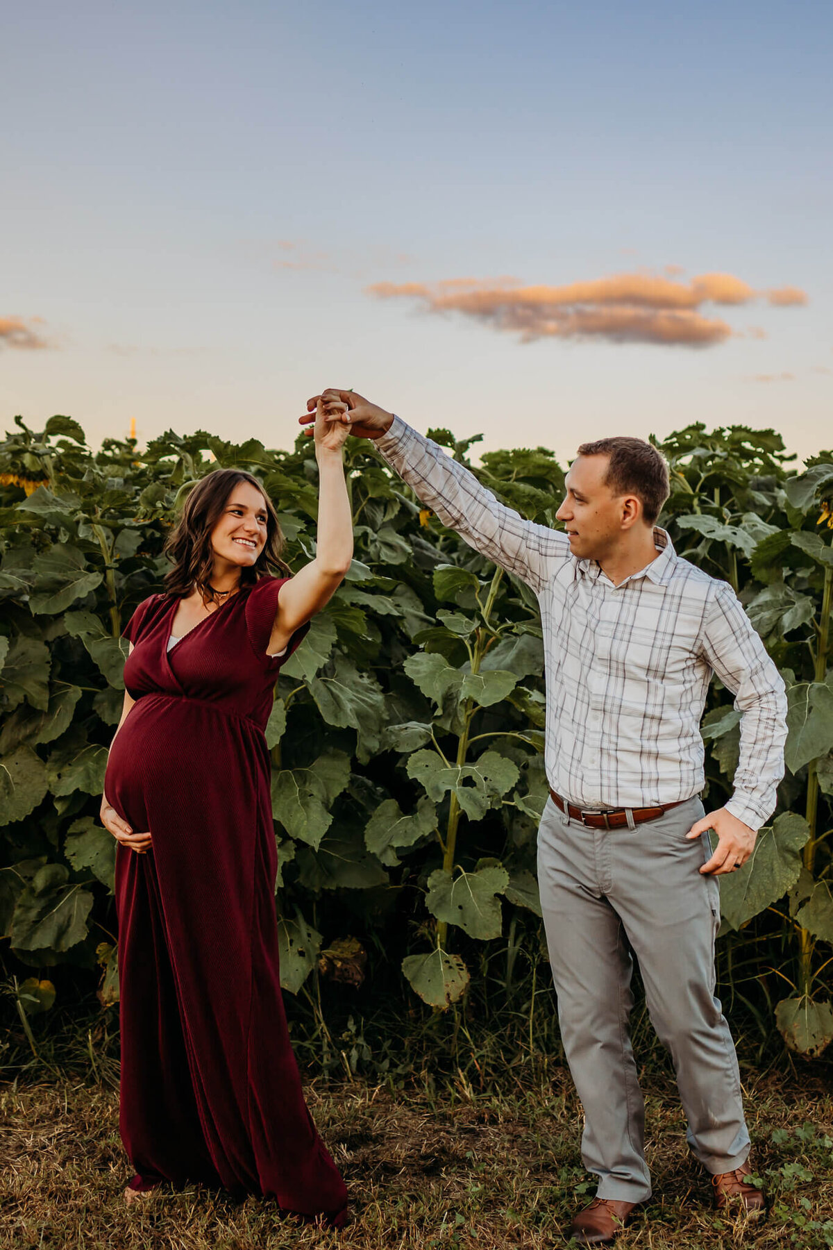 baby bump dancing in field for maternity pictures