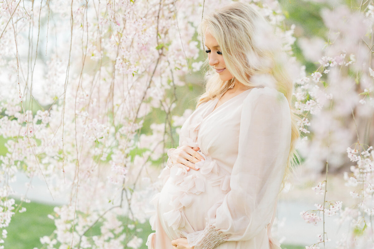 Pregnant woman holding belly in Bristol, RI at Blithewold Mansion taken by best Maternity photographer in Rhode Island