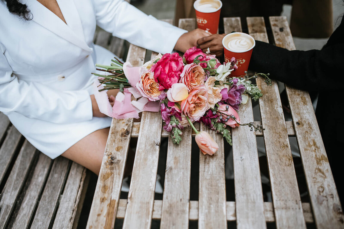 Brides-hold-hands-with-coffee-flowers