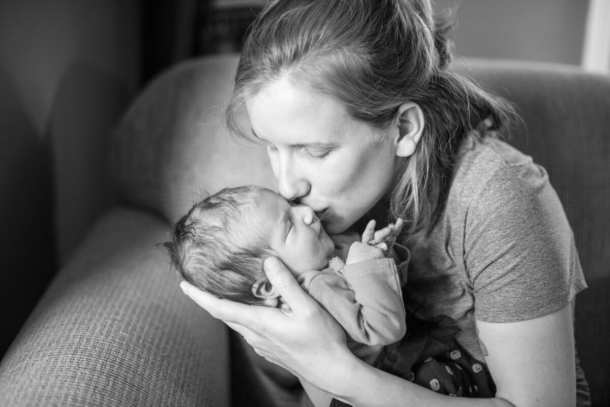 Mom kissing baby at home newborn photography Asheville, NC