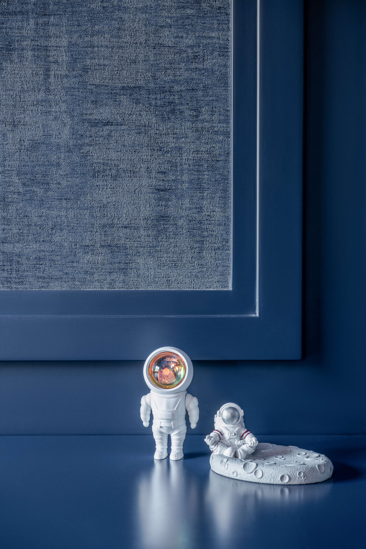 Space-themed trinkets in a boy's blue outer space themed room.