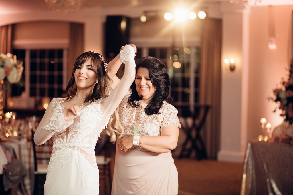 Wedding Photograph Of Bride Raising Her Hand While Dancing With  Woman Los Angeles