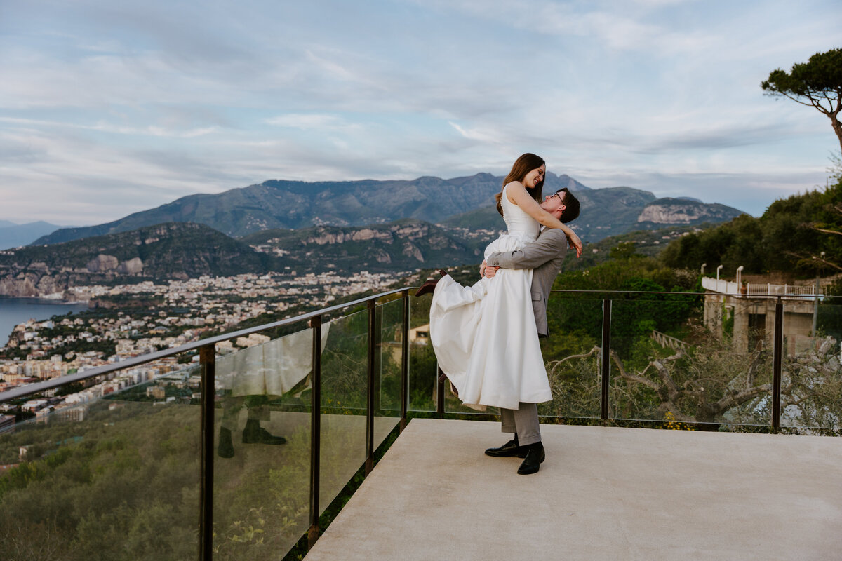 Couple hugging on Sorrento terrace at sunset