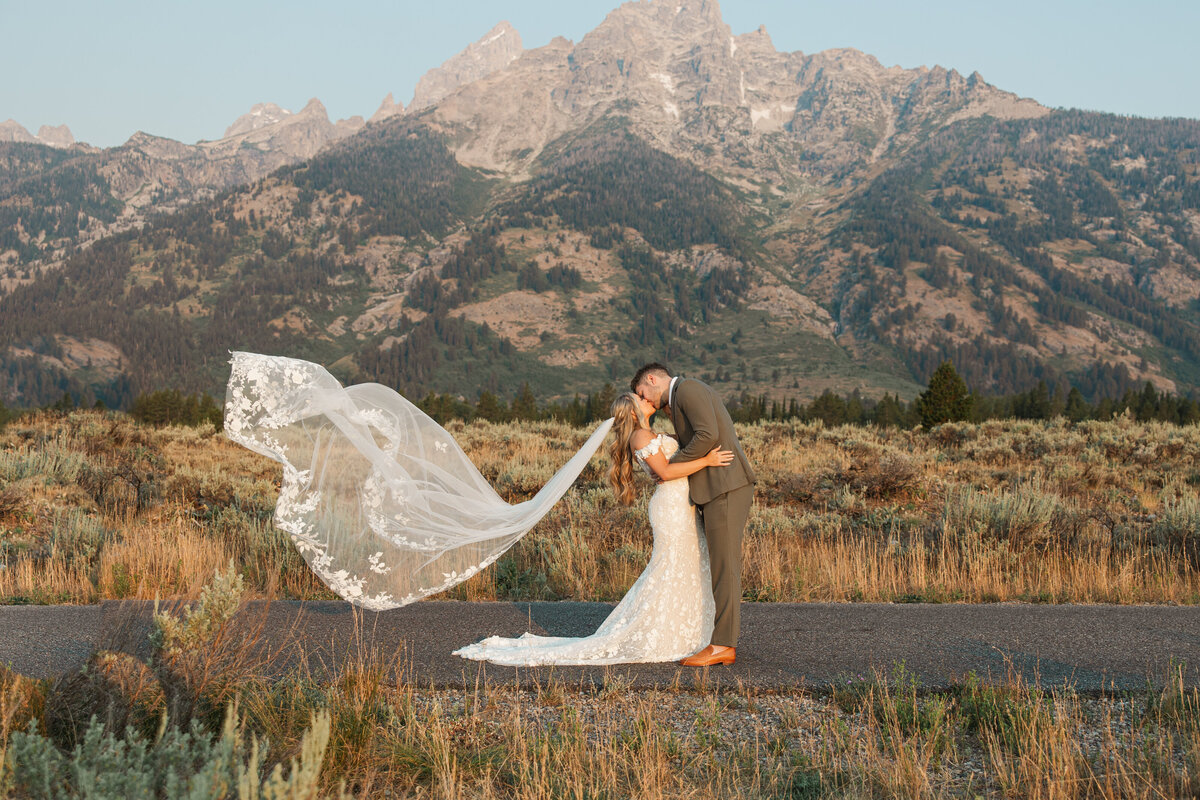 Photo of Groom kissing bride in the Grand Tetons