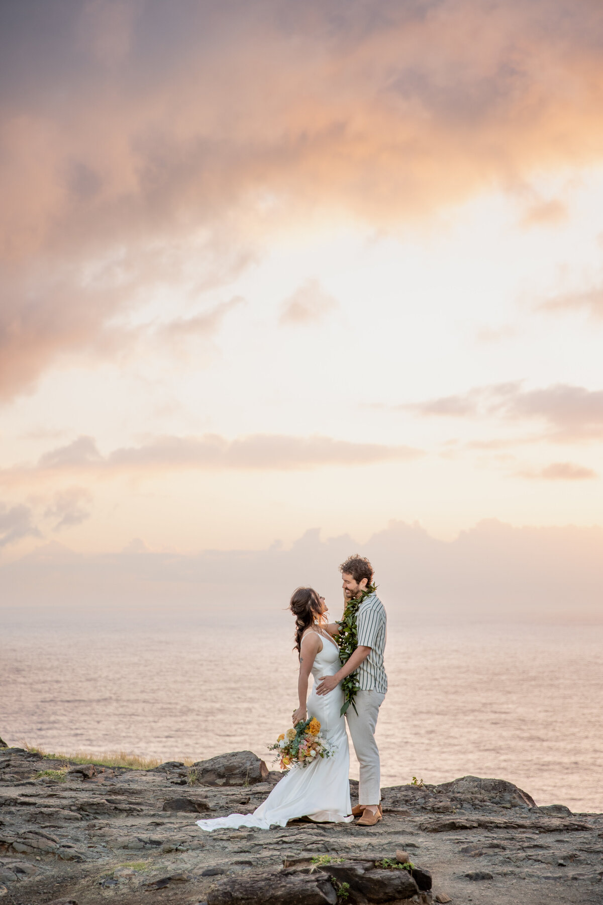 Maui Wedding Photographer captures bride and groom hugging for sunrise bridal portraits