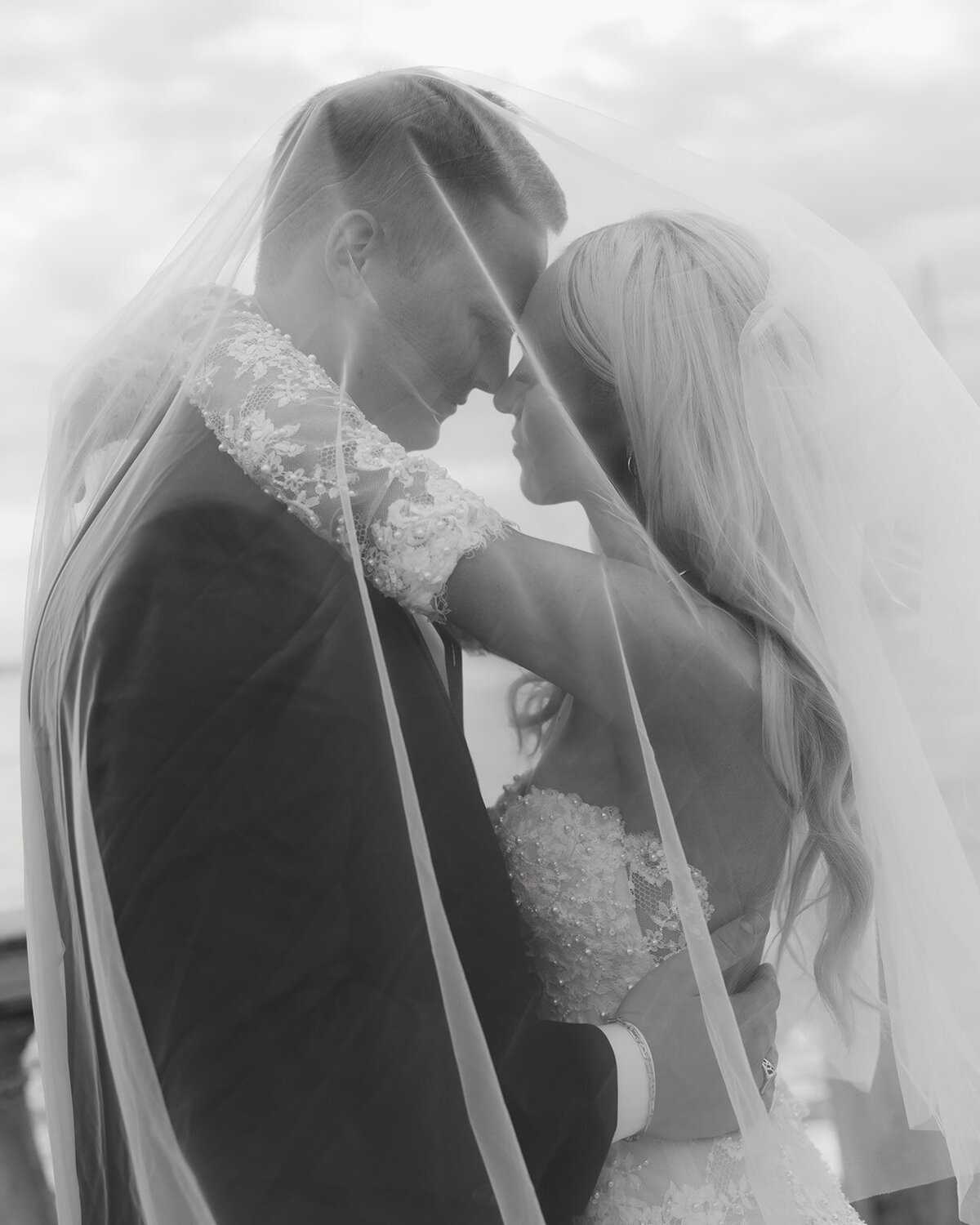 bride and groom kiss under the veil