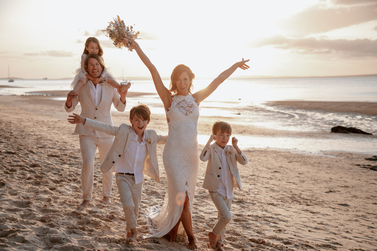Bridal portraits on the beach at sunset with their children