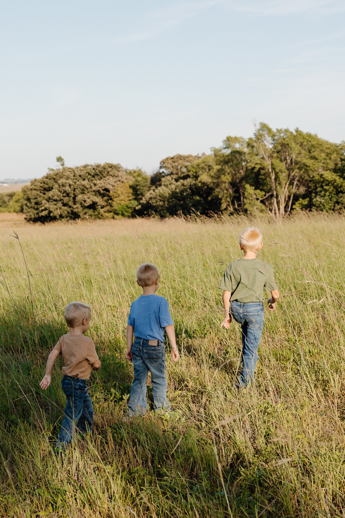 Three kids walking in a field