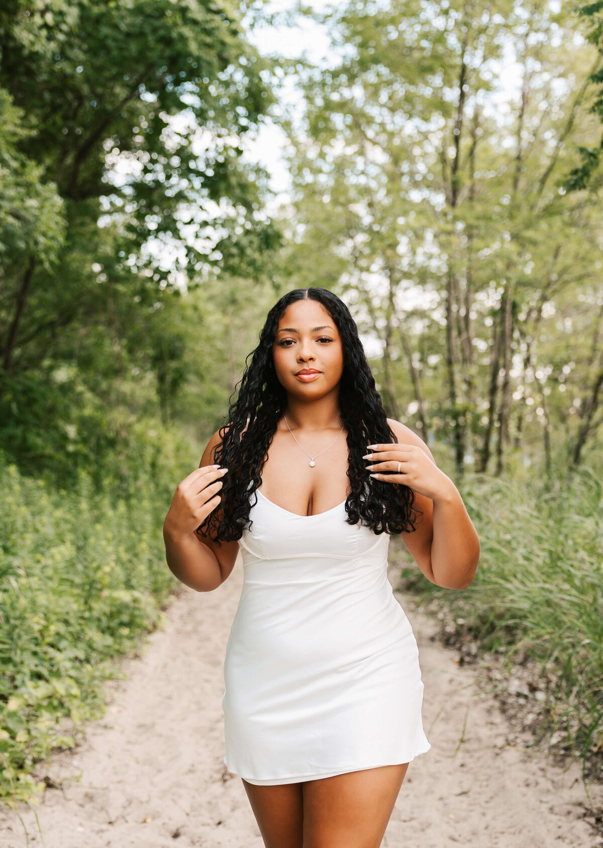 Beautiful high school senior from Erie Pa walking on a path in the sand at the beach