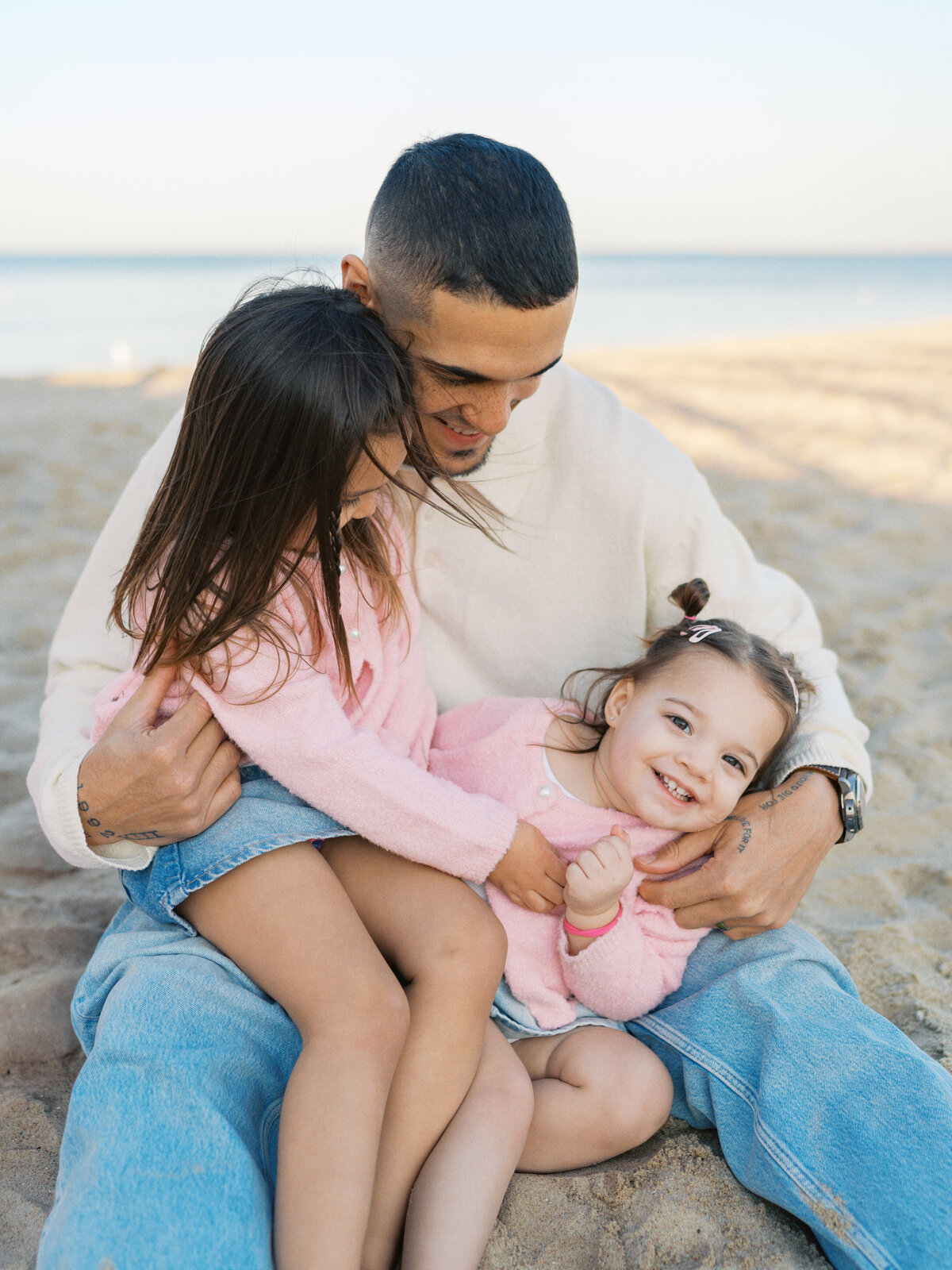 father-tickling-daughters-at-the-beach