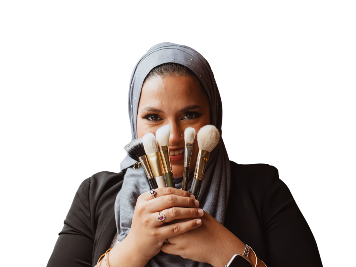 Close-up of Maya applying makeup with calm focus