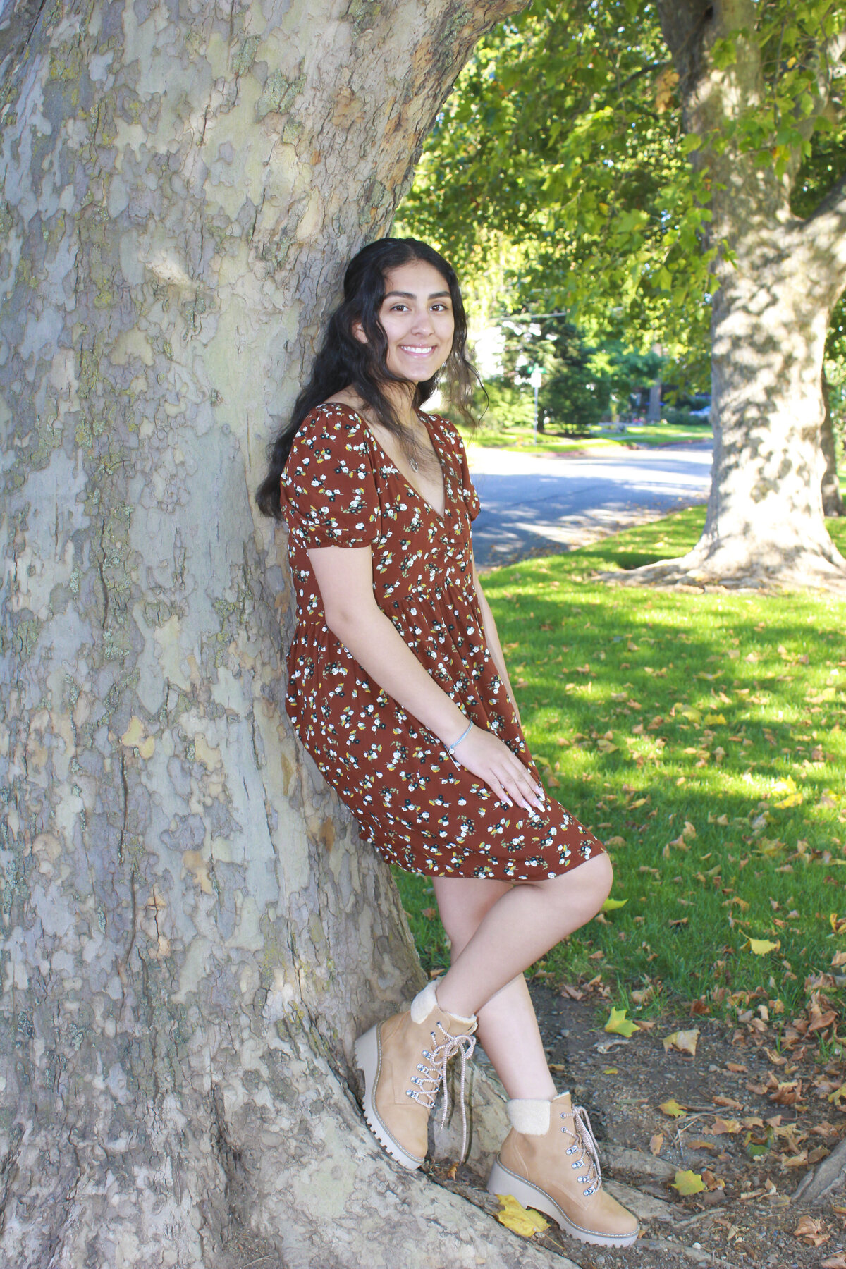 lady leaning on tree smiling