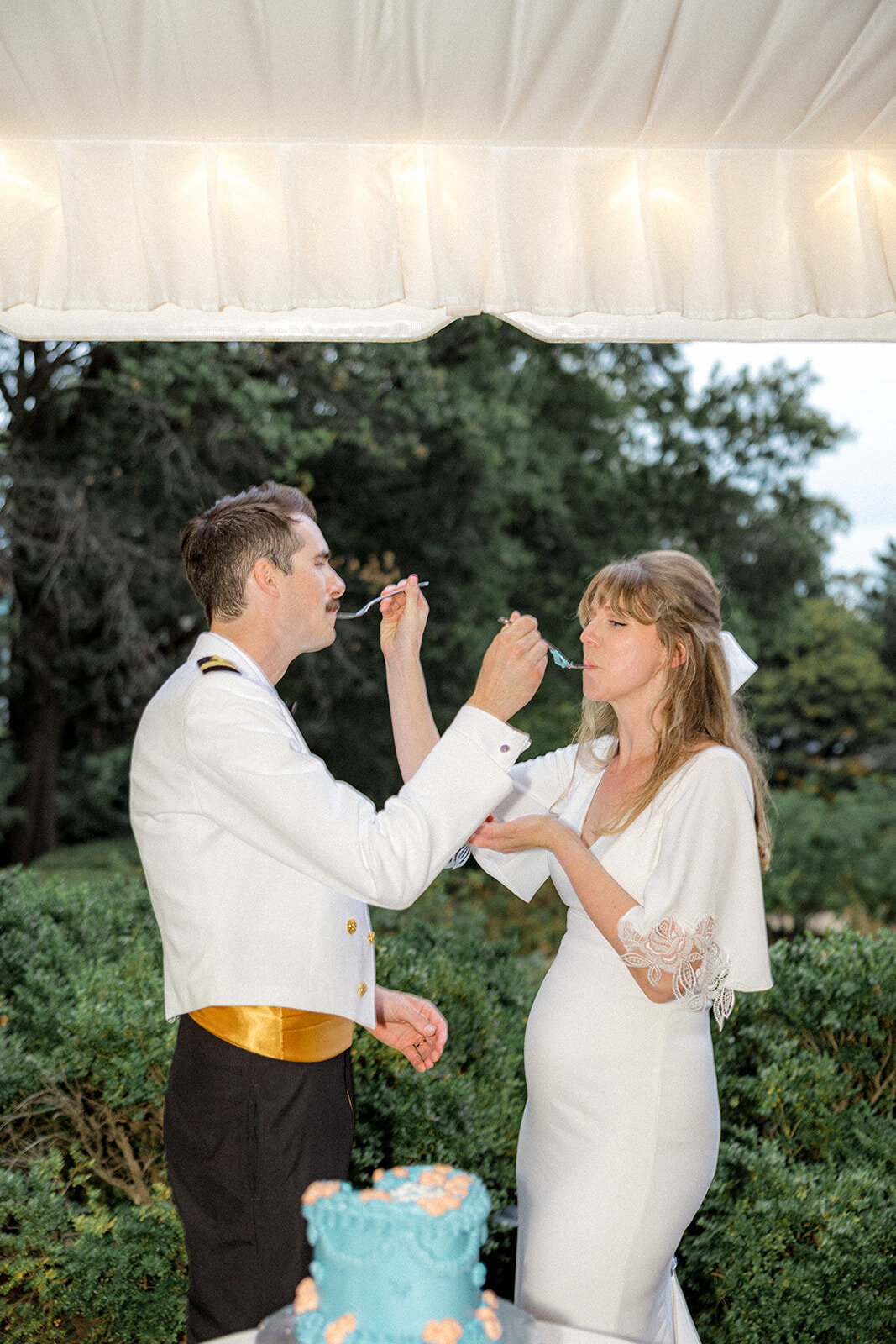 Bride and groom tasting wedding cake