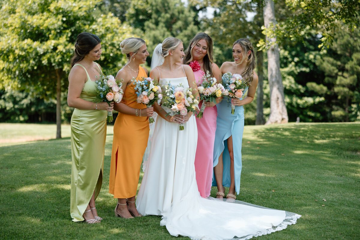 Bride with her bridesmaids wearing mix matched dresses