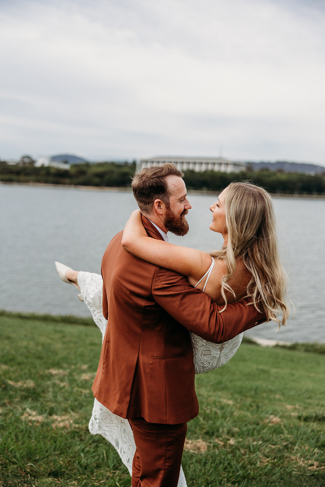 Groom swooping up his bride during sunset photos at the Marion
