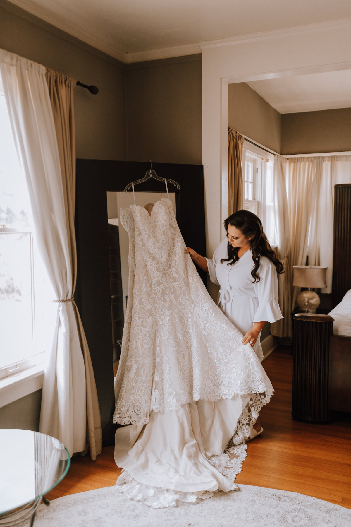bride looking at dress at manor house