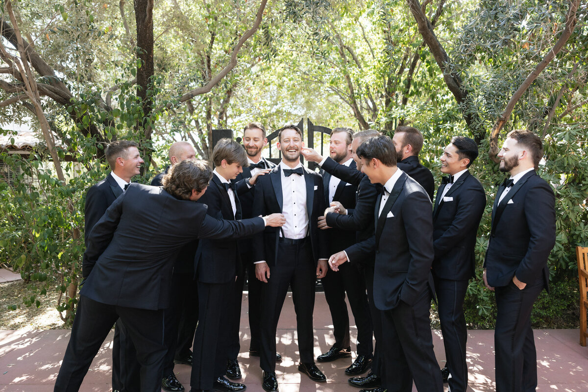 Groomsmen helping groom get ready at El Chorro wedding venue in Arizona