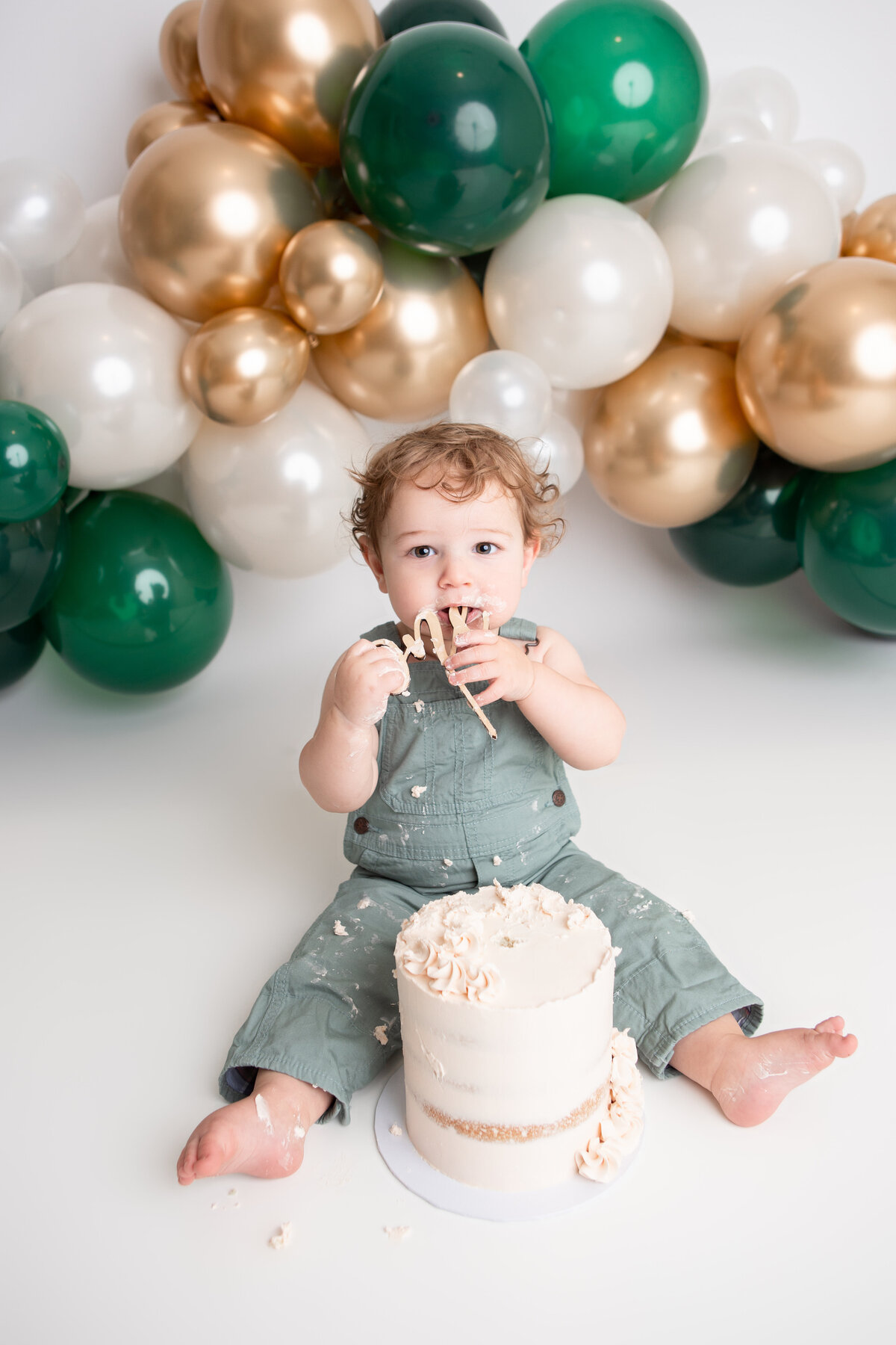 Edmonton baby boy first birthday cake smash green gold white balloon garland