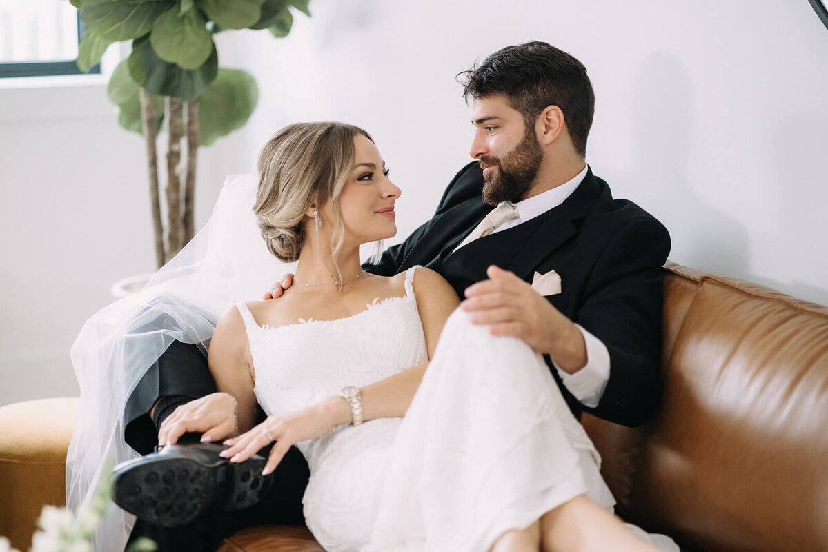 Bride and groom relaxing on a sofa before their Finger Lakes Wedding, NY