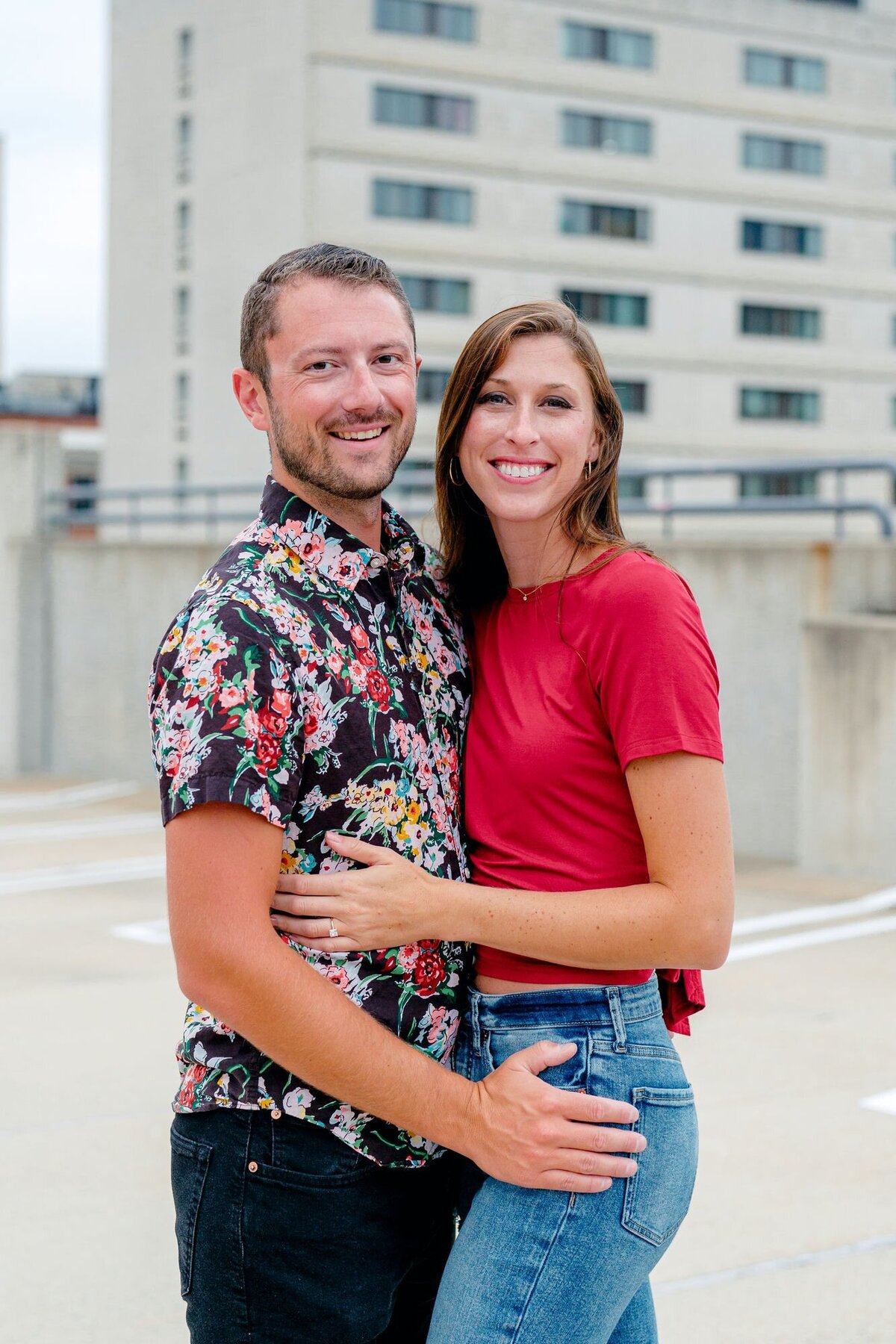 couple-holding-hands-facing-each-other-rooftop-engagement