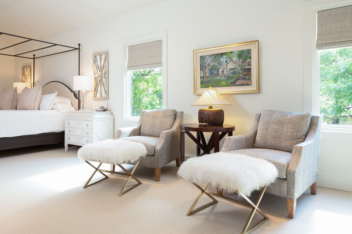 the keeping room interiors grant bedroom chairs with round wooden table and gold frame picture on wall