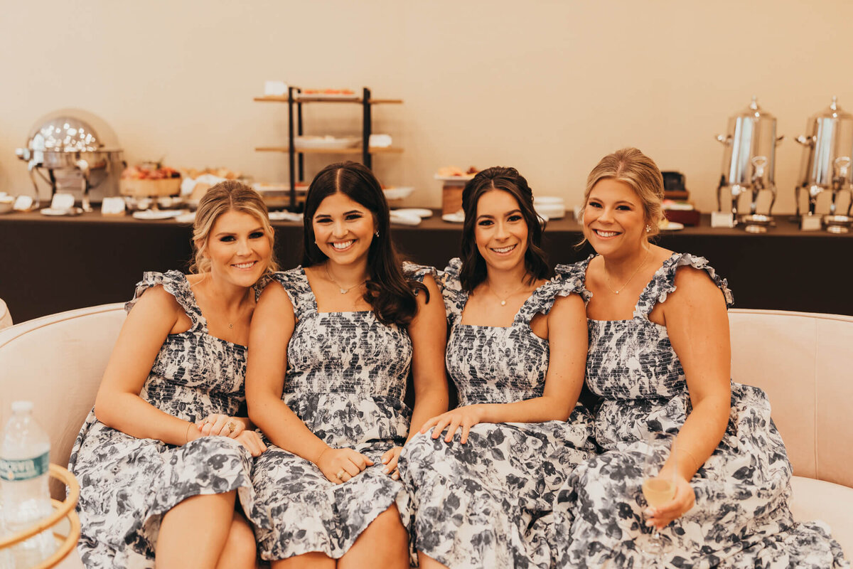 bridesmaids sit on the couch of the bridal party room