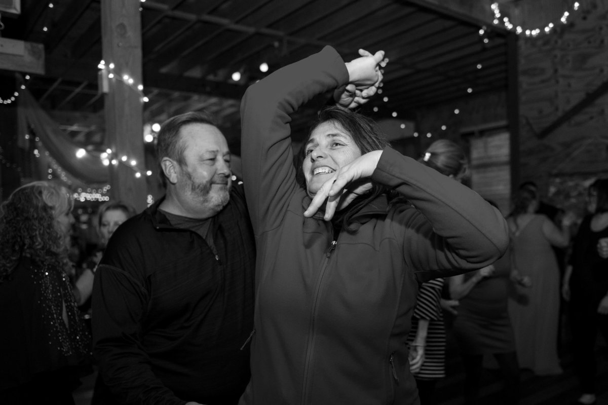 woman spun by spouse at party dance black and white photo