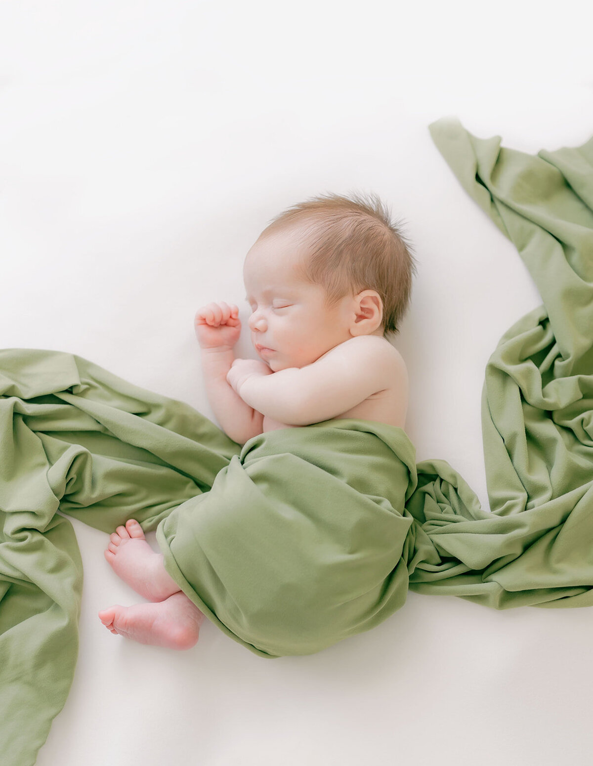 Newborn baby sleeping on side