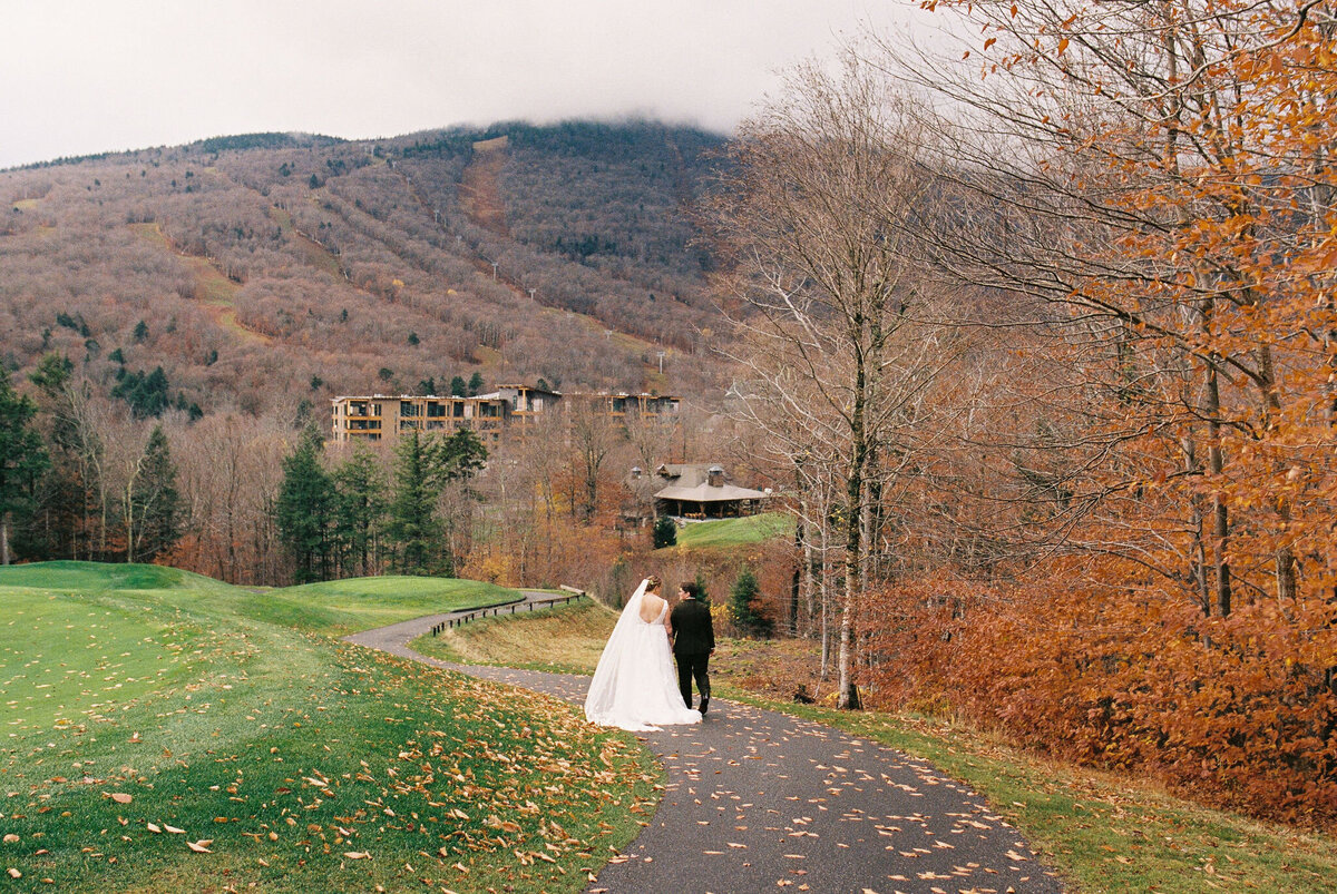 brides walking down path in fall