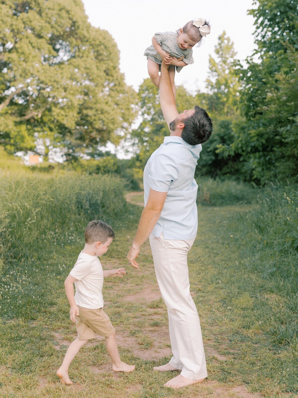 dad-lifting-young-toddler-girl-into-air