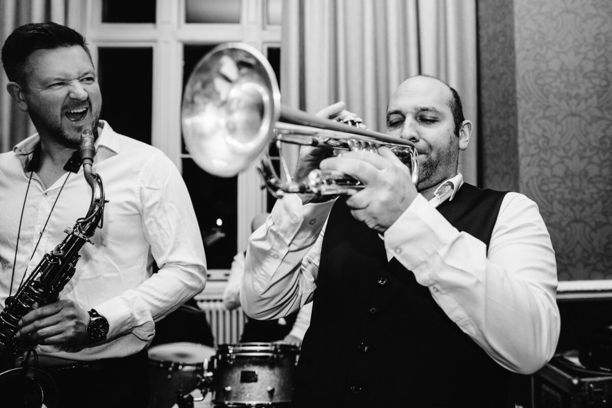 Black and white photos of musicians playing at reception