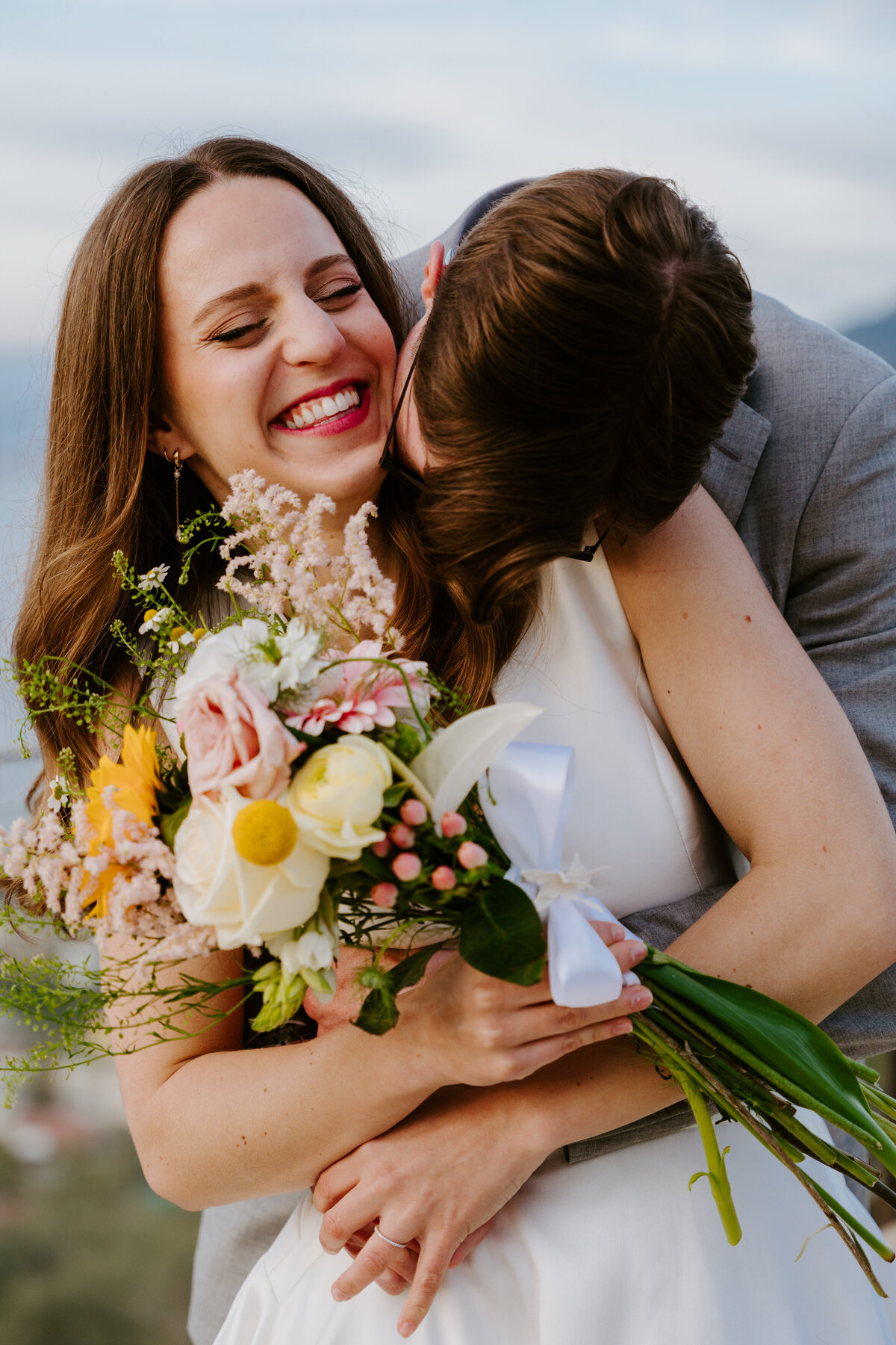Couple hugging on Sorrento terrace at sunset