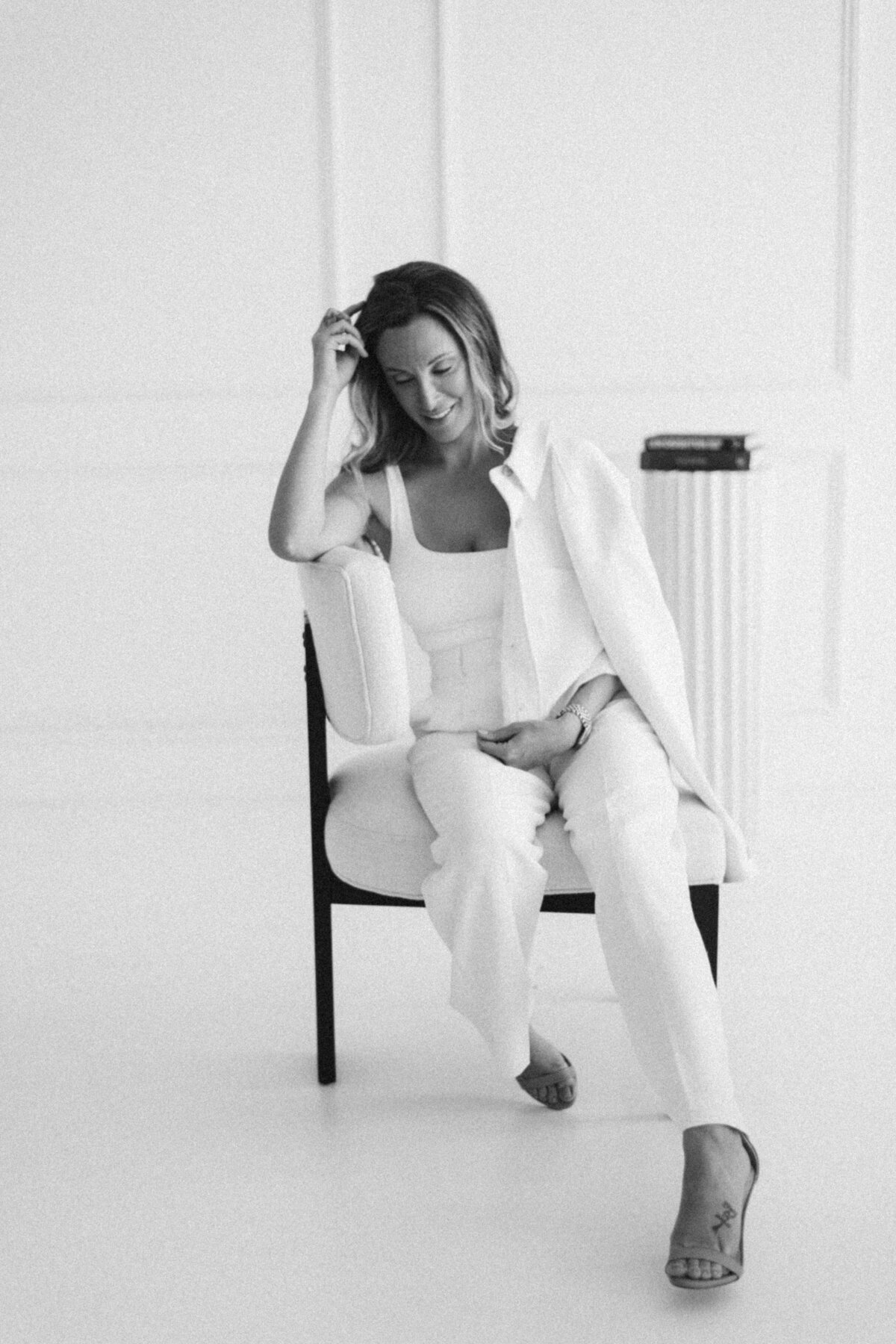 Woman black and white sitting on chair pose