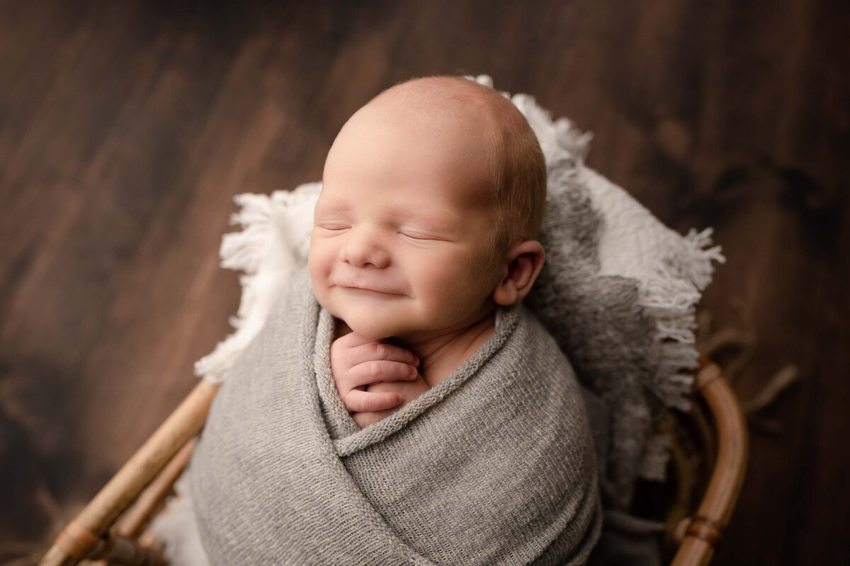 Swaddled Baby Boy Smiling In Basket