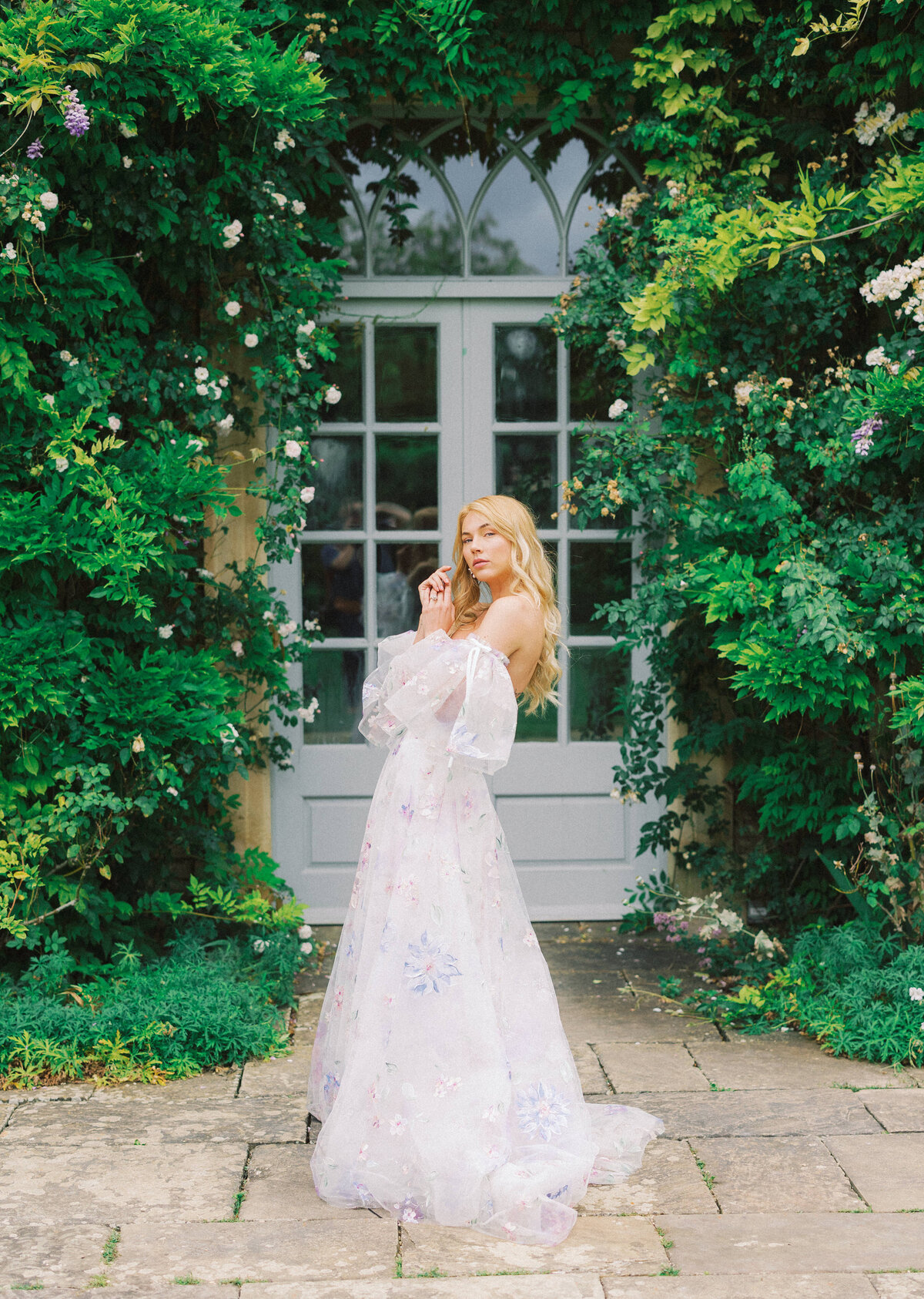 model stands in front of ivy