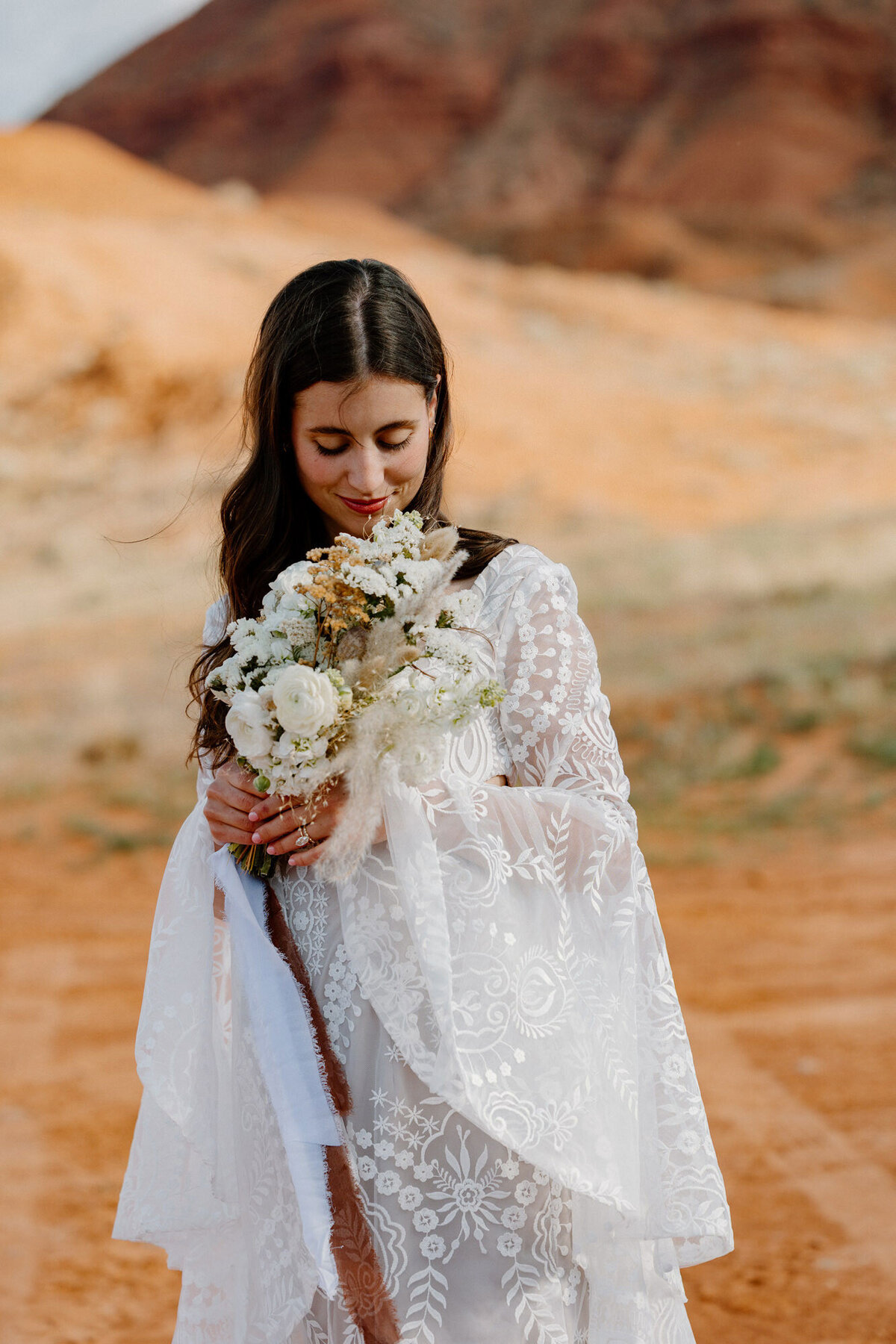 A bride admires her bouquet on her elopement day