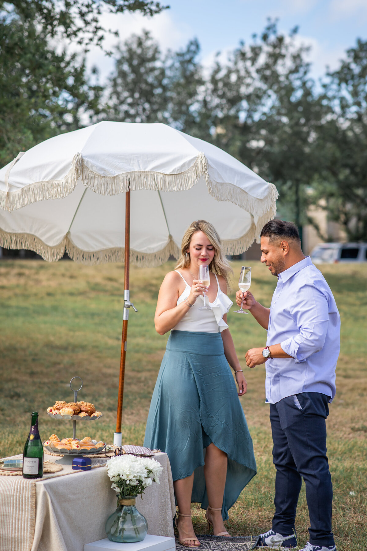 Proposal ideas couple toasting with glasses of champagne