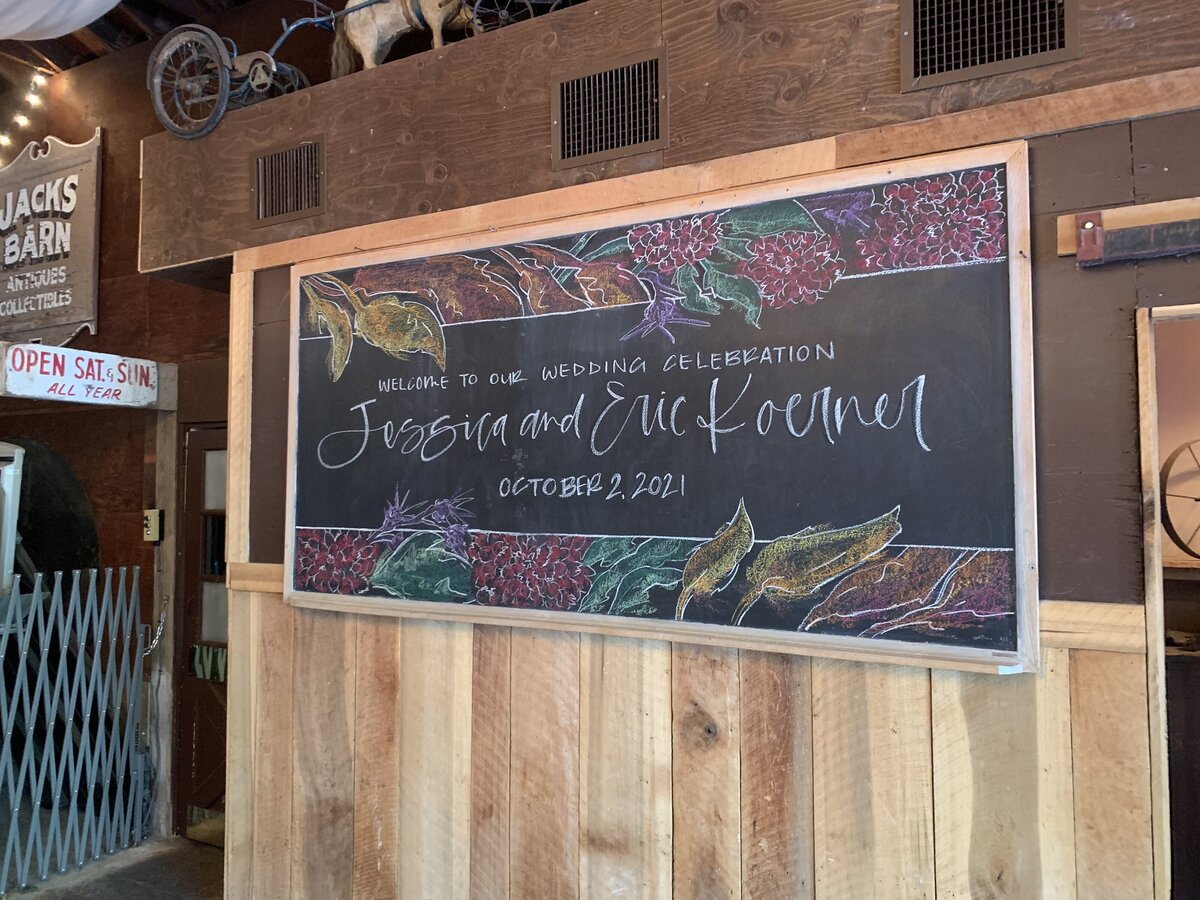 calligraphy welcome wedding sign on chalkboard at The loft at Jack's barn.