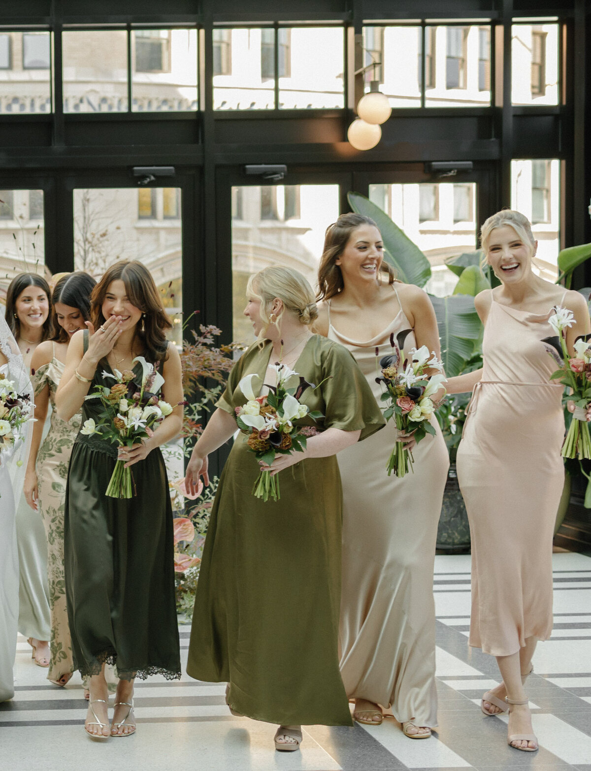 Different bridesmaids dresses at Shinola Hotel wedding in Detroit, fall wedding colors