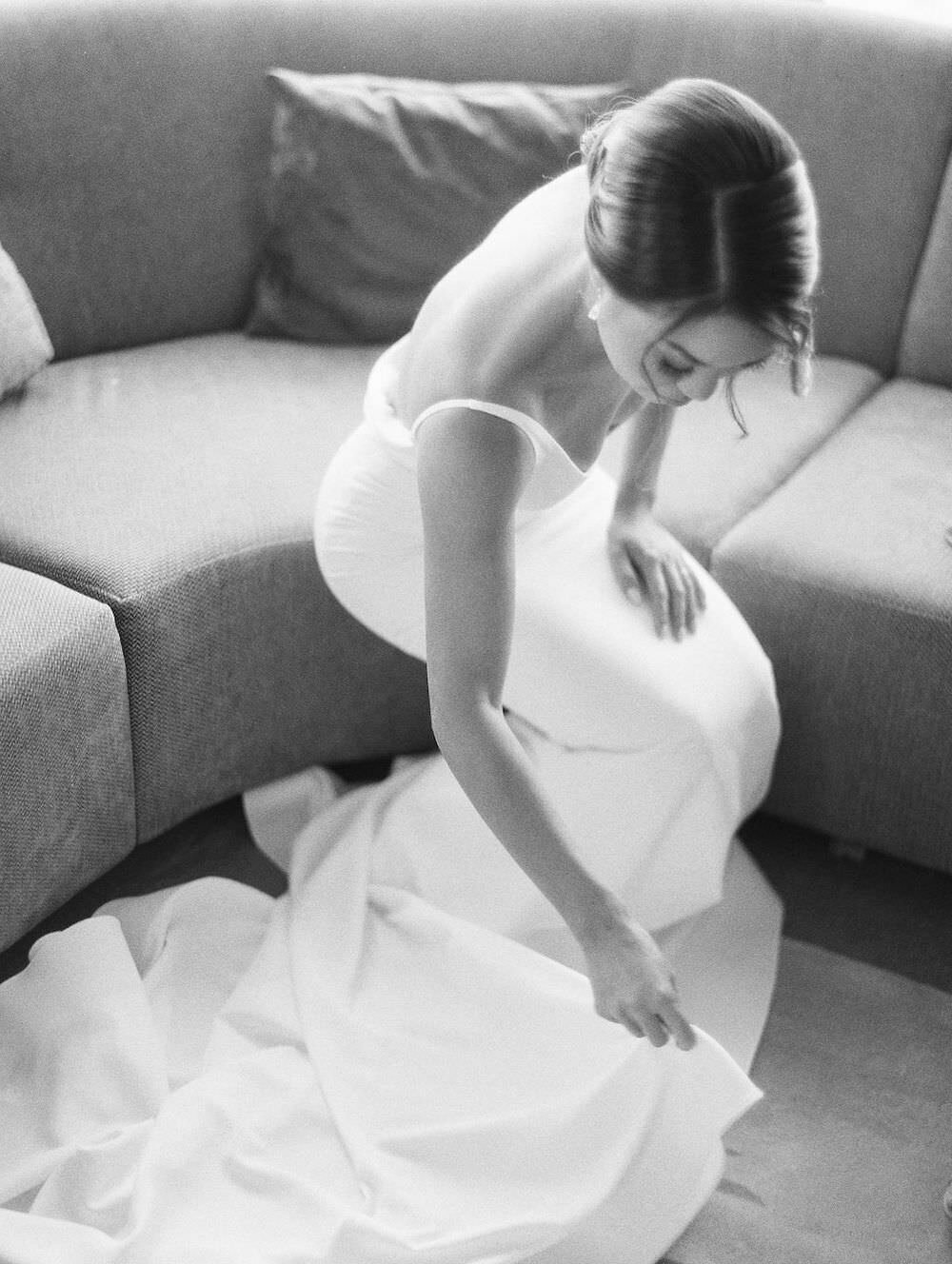 Beautiful bride fixing her wedding dress- bride's portrait